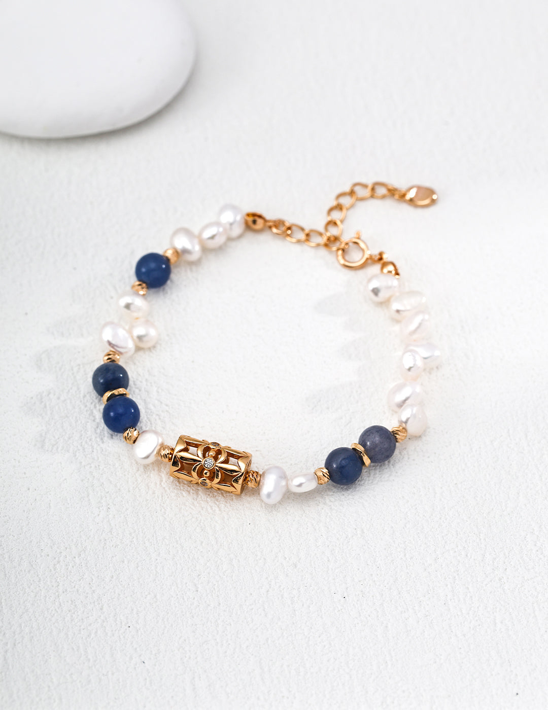 A symbol of luck, the four-leaf clover is paired with natural pearls and aventurine jade