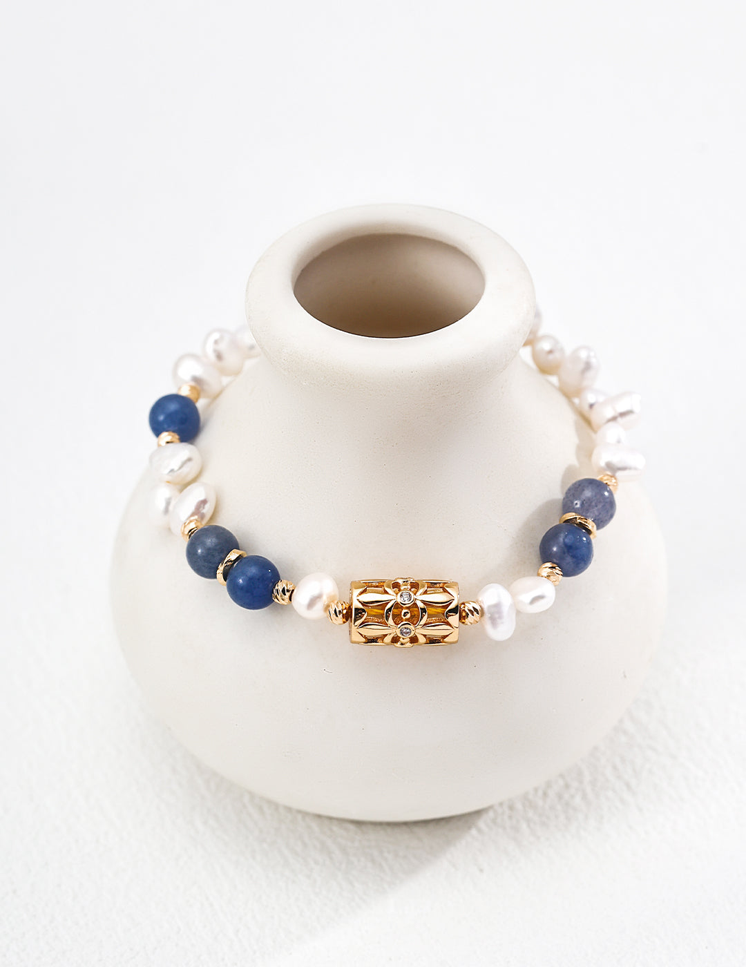 A symbol of luck, the four-leaf clover is paired with natural pearls and aventurine jade
