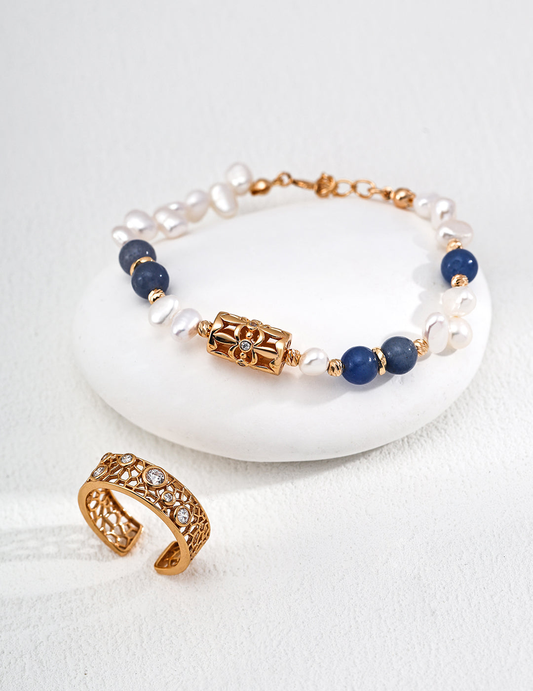 A symbol of luck, the four-leaf clover is paired with natural pearls and aventurine jade